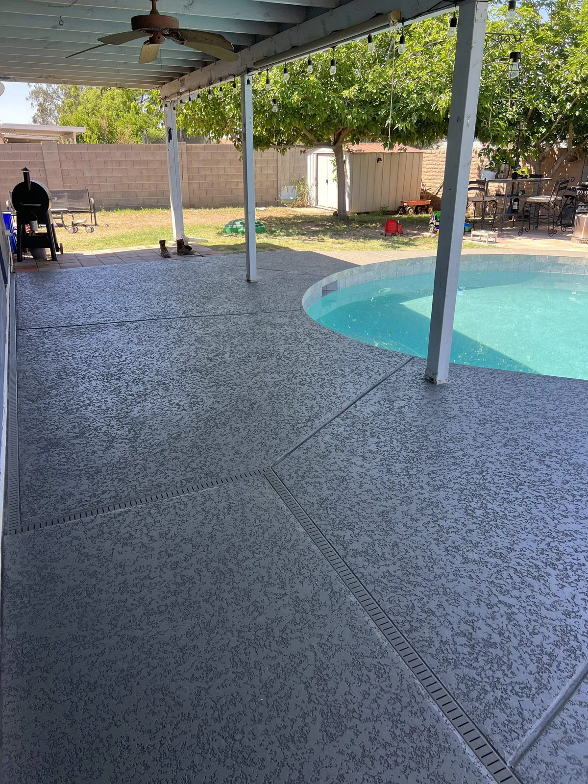 Charcoal acrylic lace pool deck after crack repair and resurfacing, same covered patio