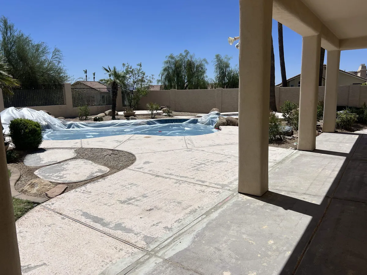 Older acrylic cool deck coating in the Phoenix Valley peeled and worn through to bare concrete in patches
