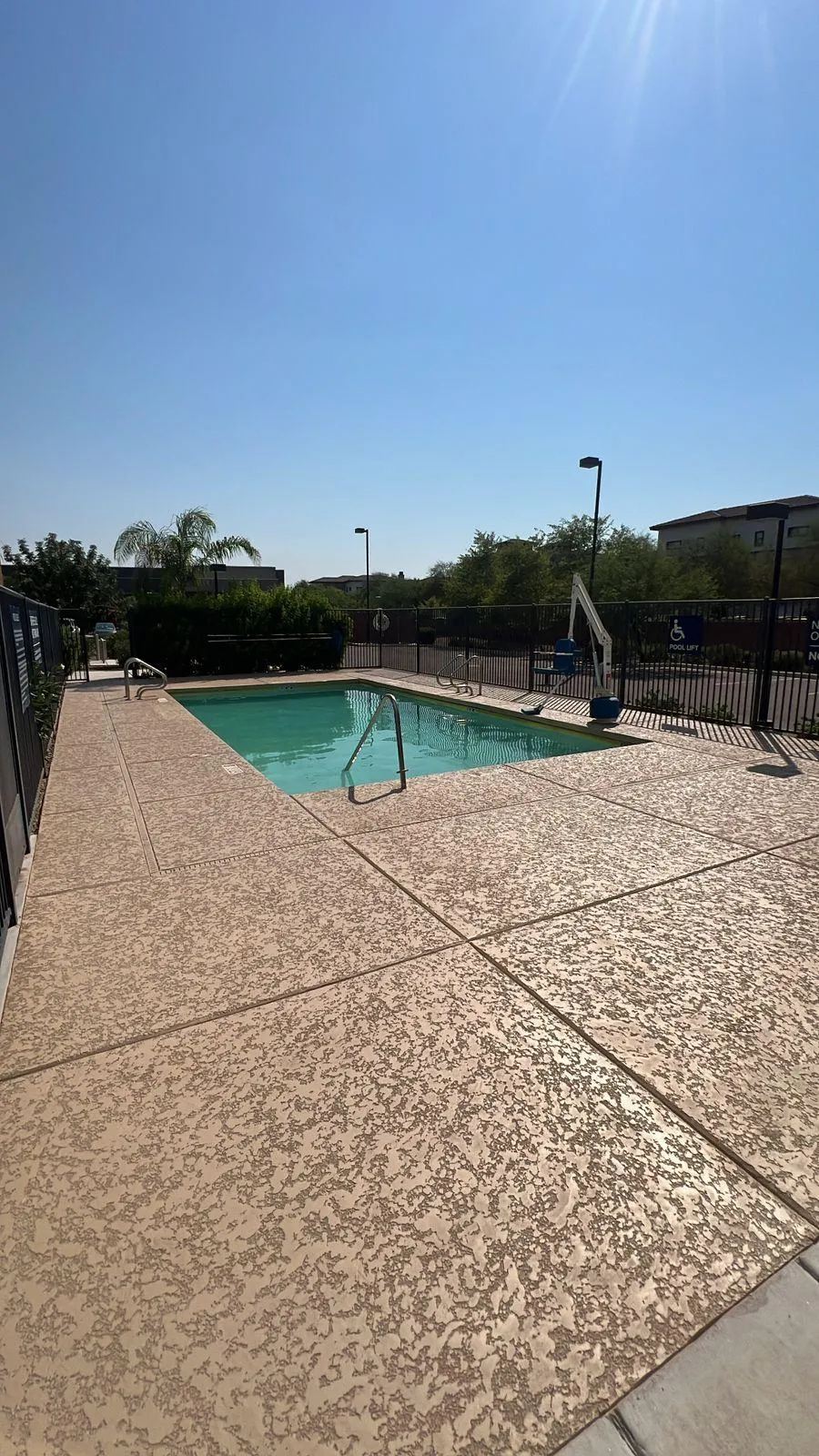 Commercial pool deck ADA-compliant surface installation for community pool