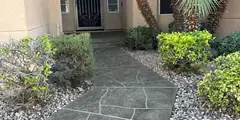 Stamped concrete overlay pool deck with decorative stone pattern design